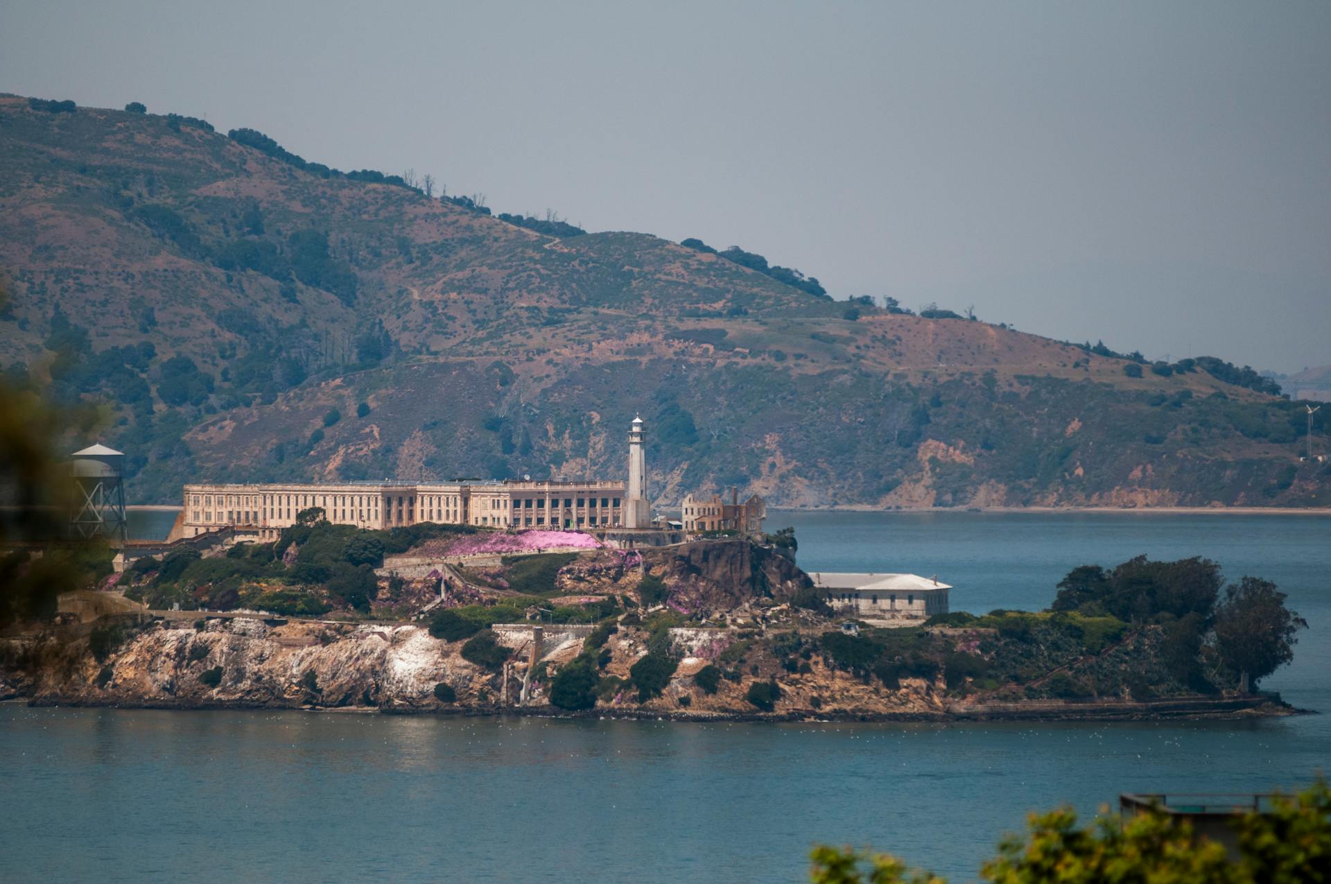Scenic view of Alcatraz Island in San Francisco Bay with historic prison buildings.