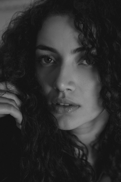 Black and White Portrait of a Woman with Curly Hair · Free Stock Photo