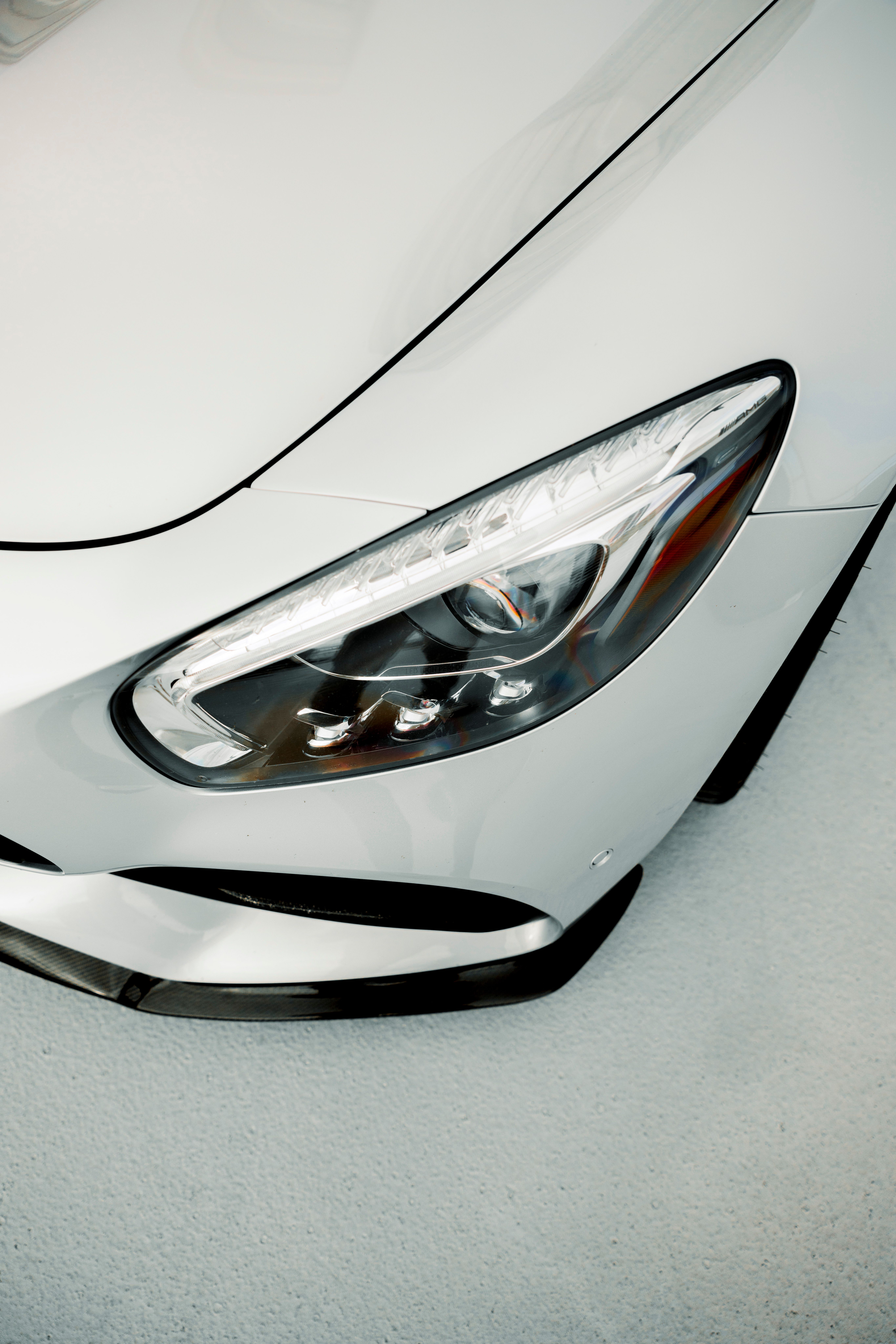 Elegant Close-up of Luxury Car's Headlight · Free Stock Photo