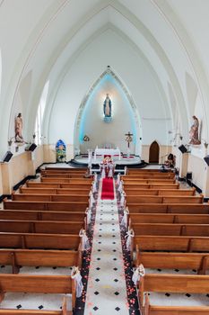A stunning view of a church interior featuring an elegant altar with pews lined neatly.