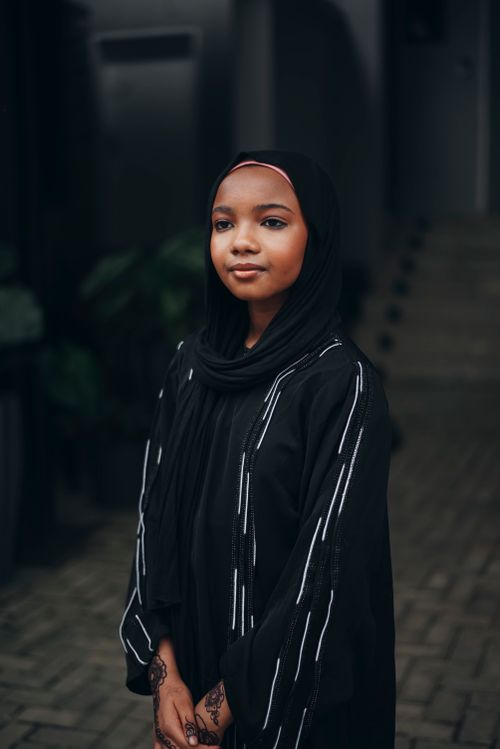 Free Portrait of a young Muslim woman in a black hijab, showcasing modern fashion in Nigeria. Stock Photo
