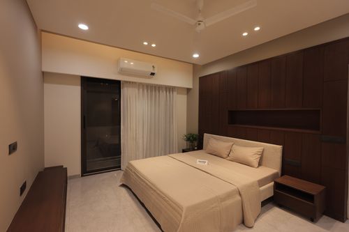 Free Contemporary bedroom design featuring wooden accents and soft lighting for a cozy ambiance. Stock Photo