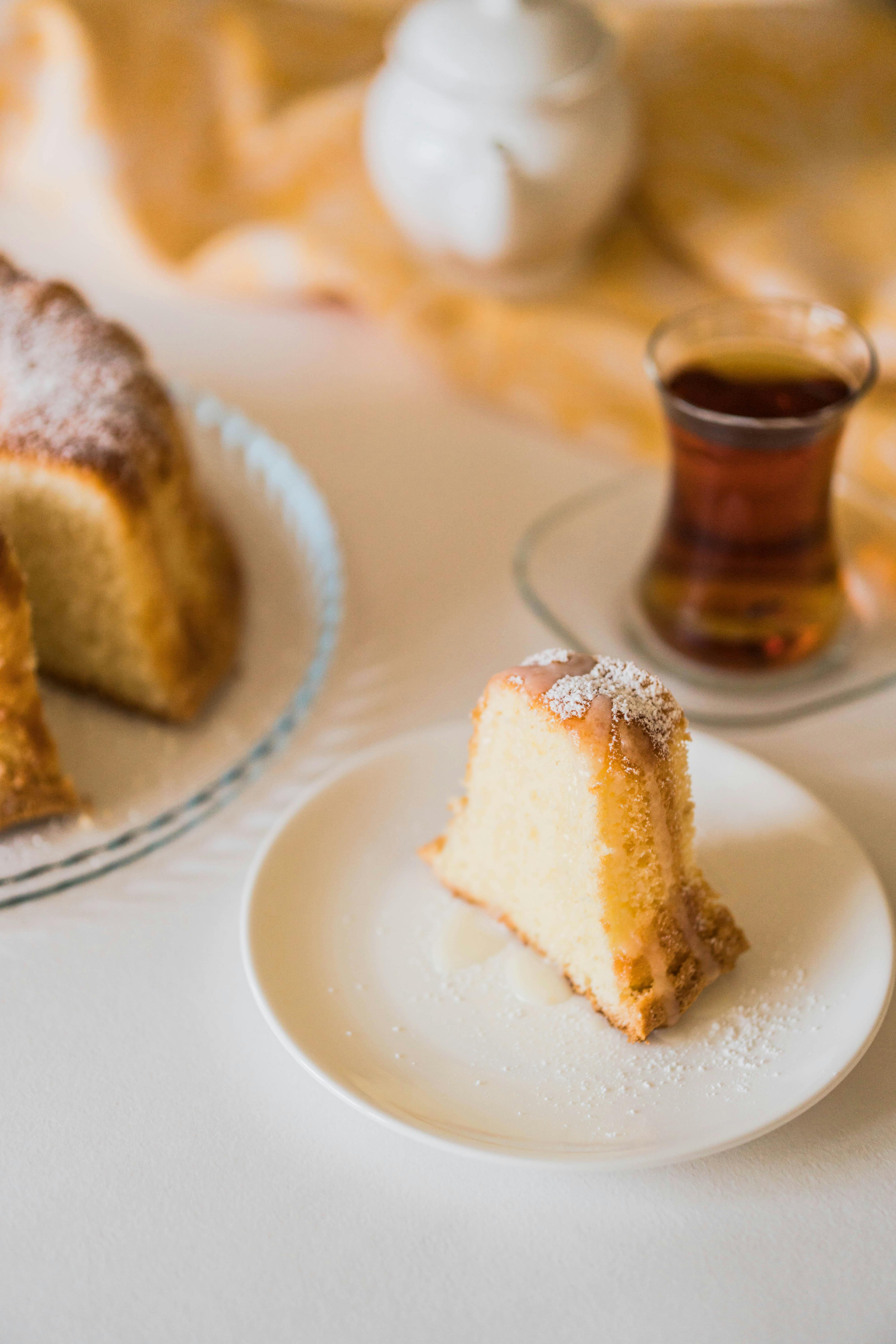 Fresh cake slice with traditional tea setting, showcasing Azerbaijani hospitality.