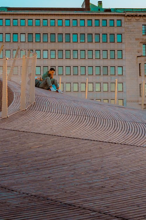 Free A man enjoys a quiet moment on a unique rooftop in Helsinki, Finland. Stock Photo