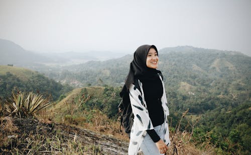 Happy ethnic female in exotic mountains