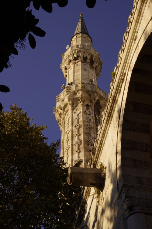 Free Detailed view of an Ottoman minaret with intricate architectural designs against a clear sky. Stock Photo