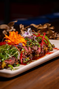 Exquisite plated gourmet dish adorned with vibrant edible flowers and fresh greens, perfect for food enthusiasts.