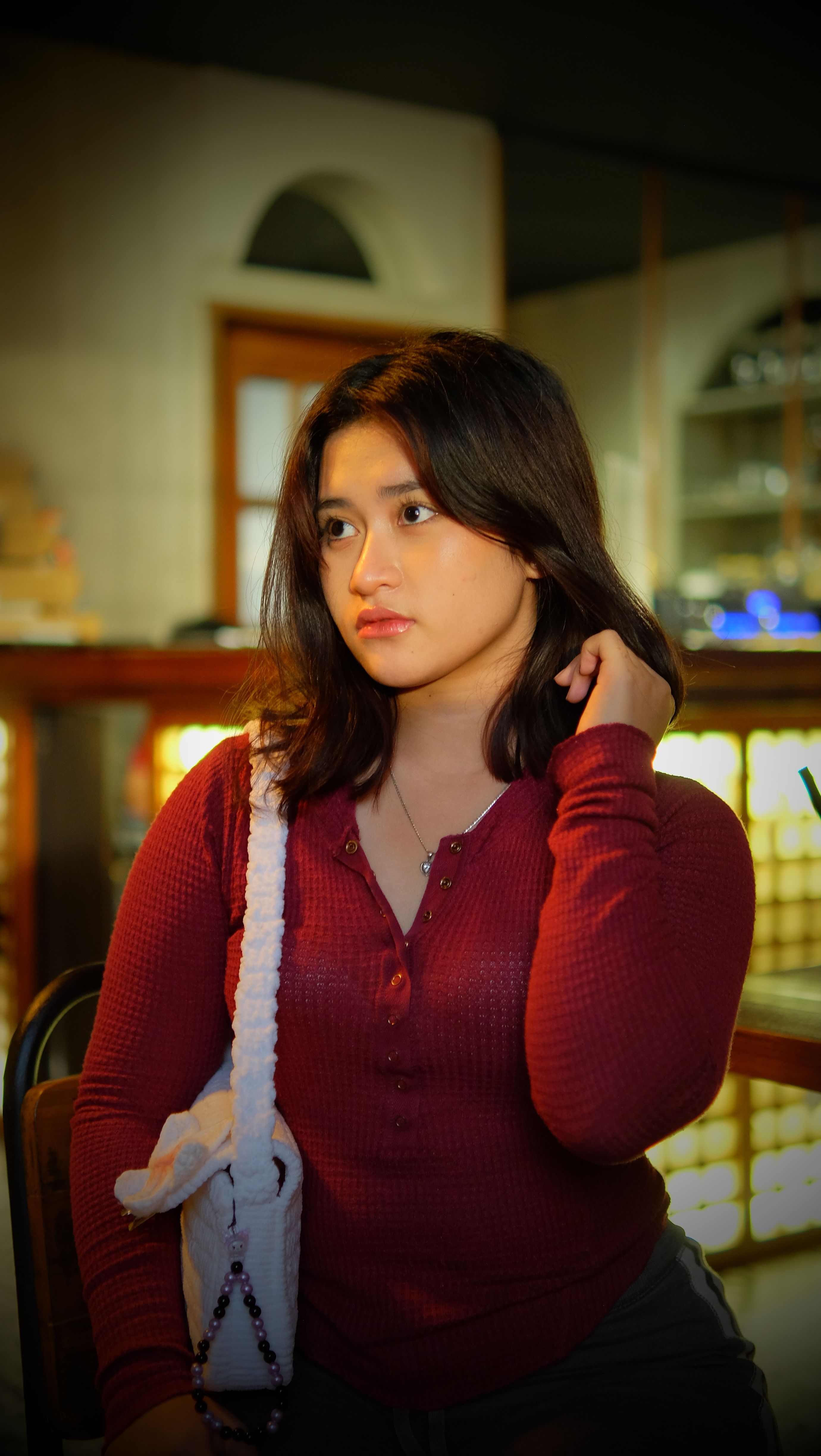 Young Woman Relaxing in a Cozy Cafe Setting