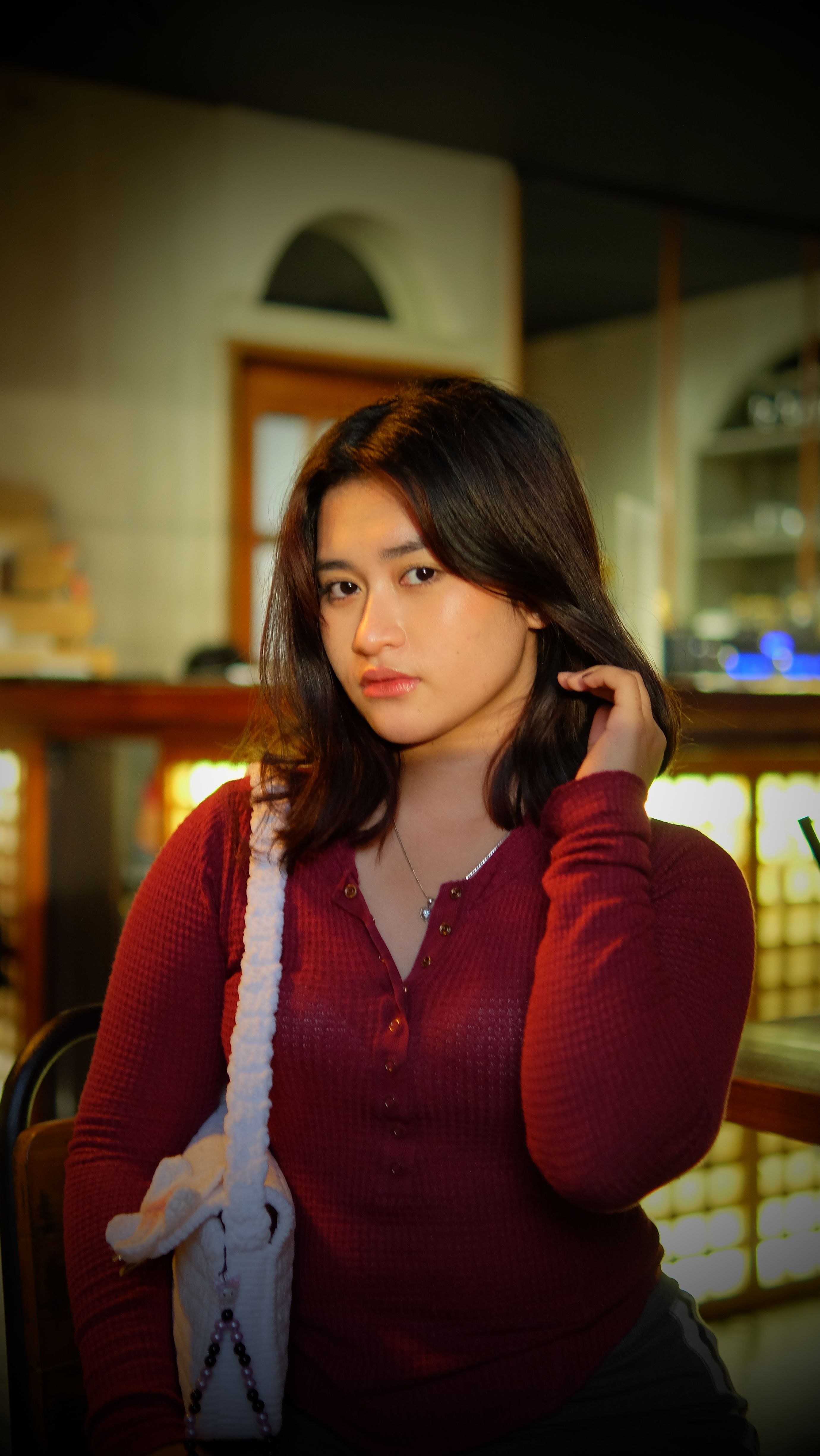Young Woman in a Cozy Café Setting