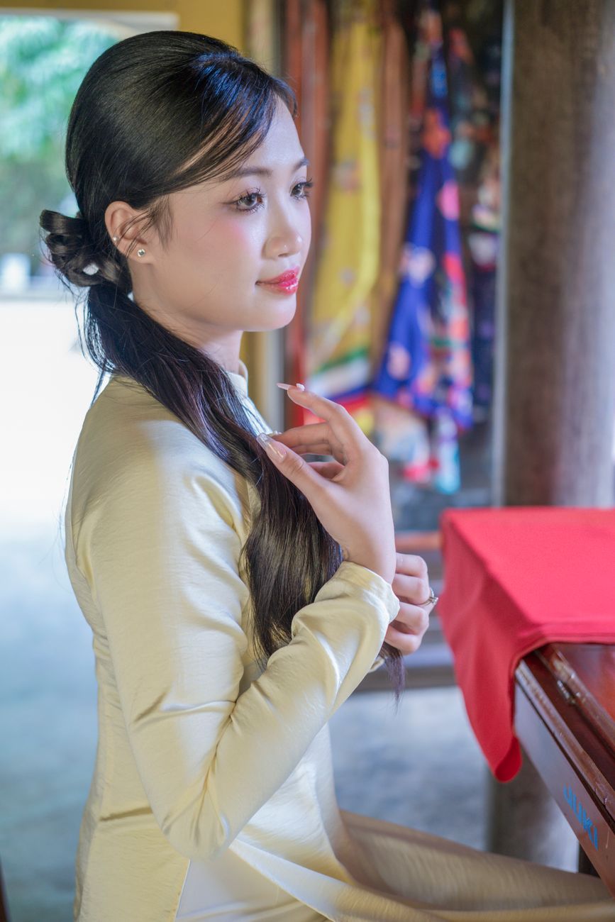 Portrait of a woman in traditional dress indoors, elegant and serene.