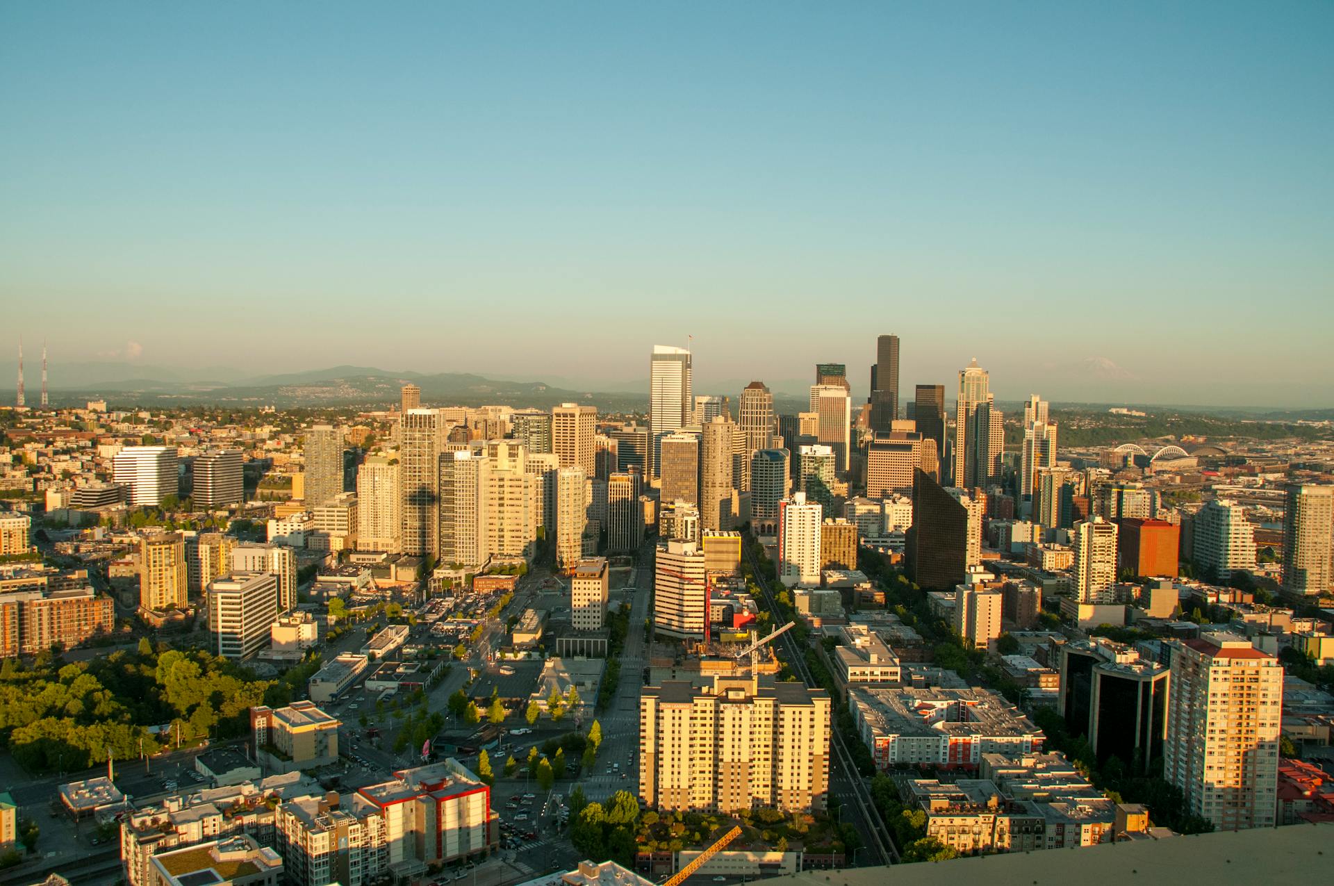 Aerial view of the Seattle skyline under clear blue skies, showcasing urban landscape.