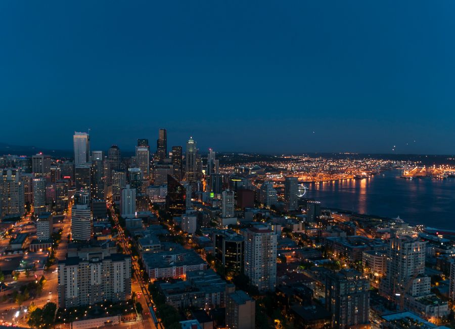 A breathtaking view of Seattle's skyline at twilight with city lights illuminating the urban landscape.