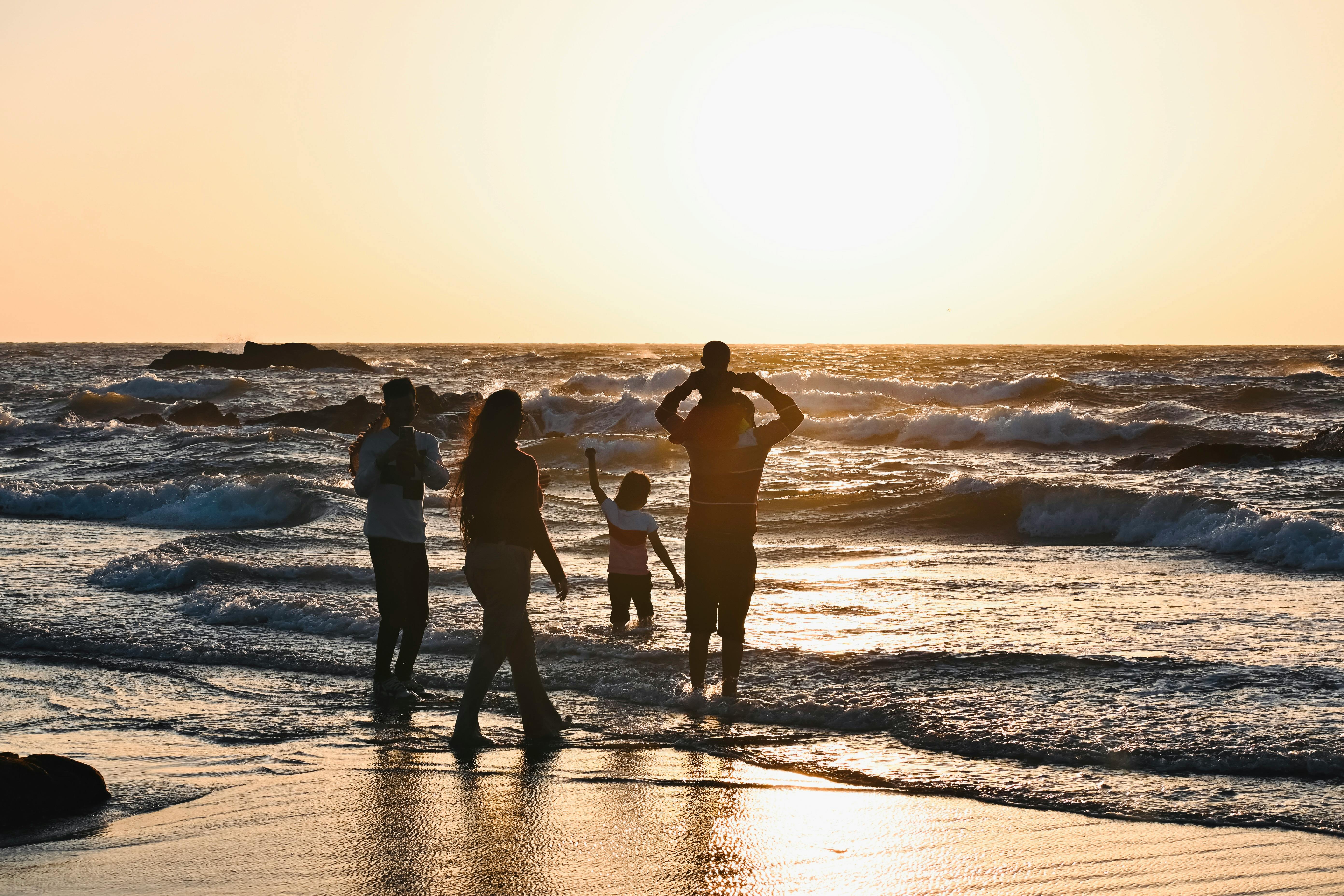 Family at the beach with ocean waves