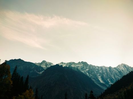 A breathtaking view of snow-capped mountains against a clear sky.