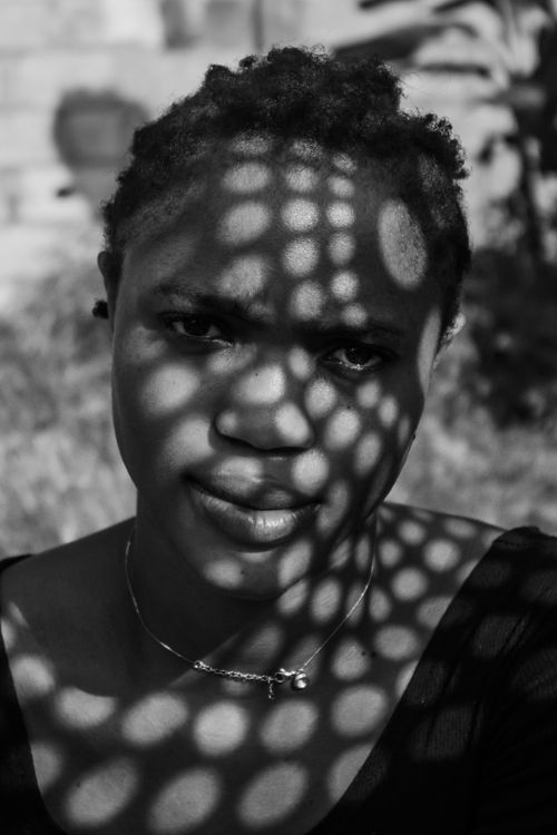 Free Black and white portrait featuring dramatic light and shadow patterns on a woman's face. Stock Photo