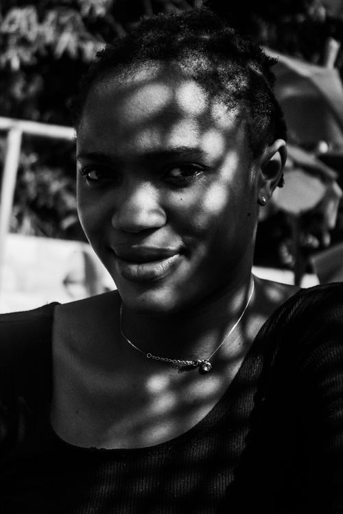 Free Artistic black and white portrait of a woman with shadows outdoors. Stock Photo