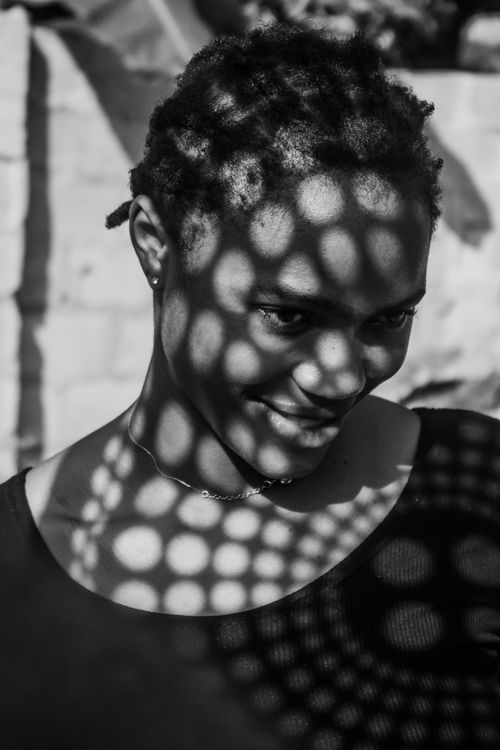Free Black and white portrait using shadows to create a captivating effect. Stock Photo