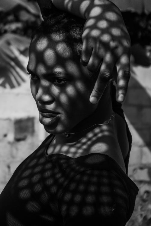 Free Striking black and white portrait with artistic shadow patterns on a woman's face and upper body. Stock Photo
