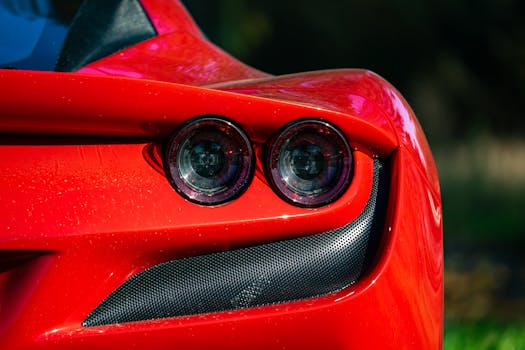 A striking close-up of a red sports car's tail light showcasing its sleek design.