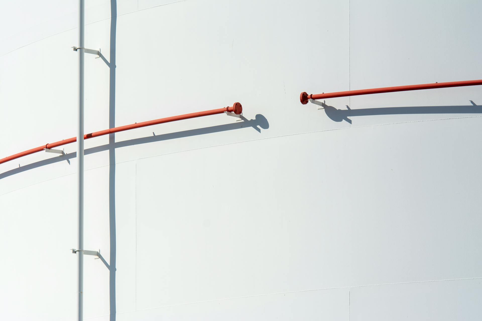 Minimalist Industrial White Surface with Pipe