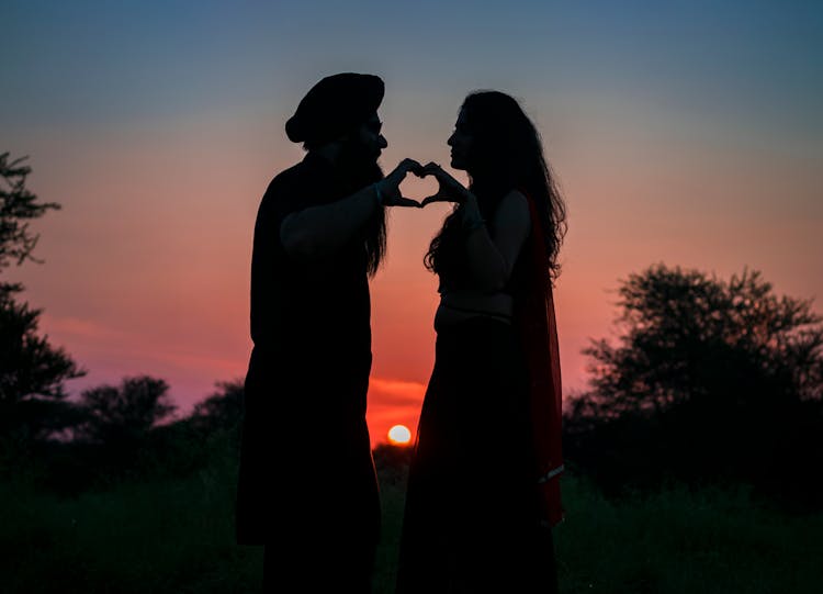 Silhouette Photo Of Couple Making A Heart Shape