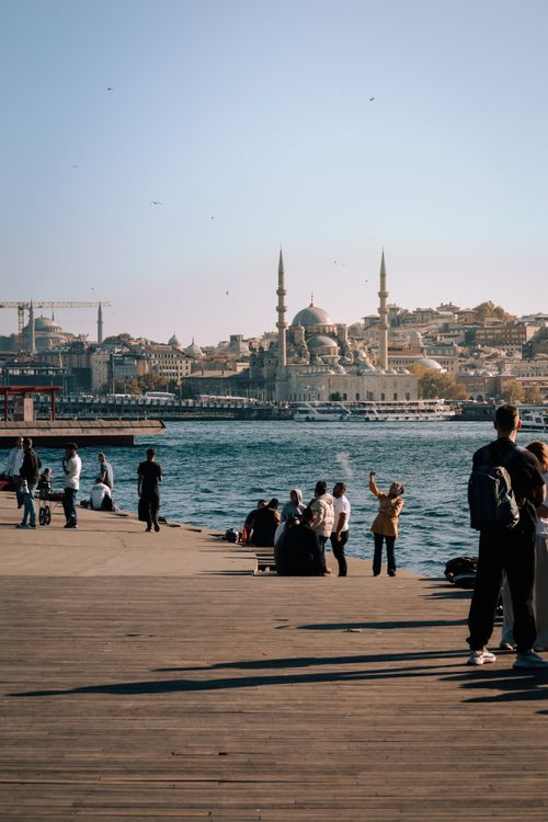 Free People enjoy the waterfront with a view of Istanbul's iconic skyline and mosques. Stock Photo