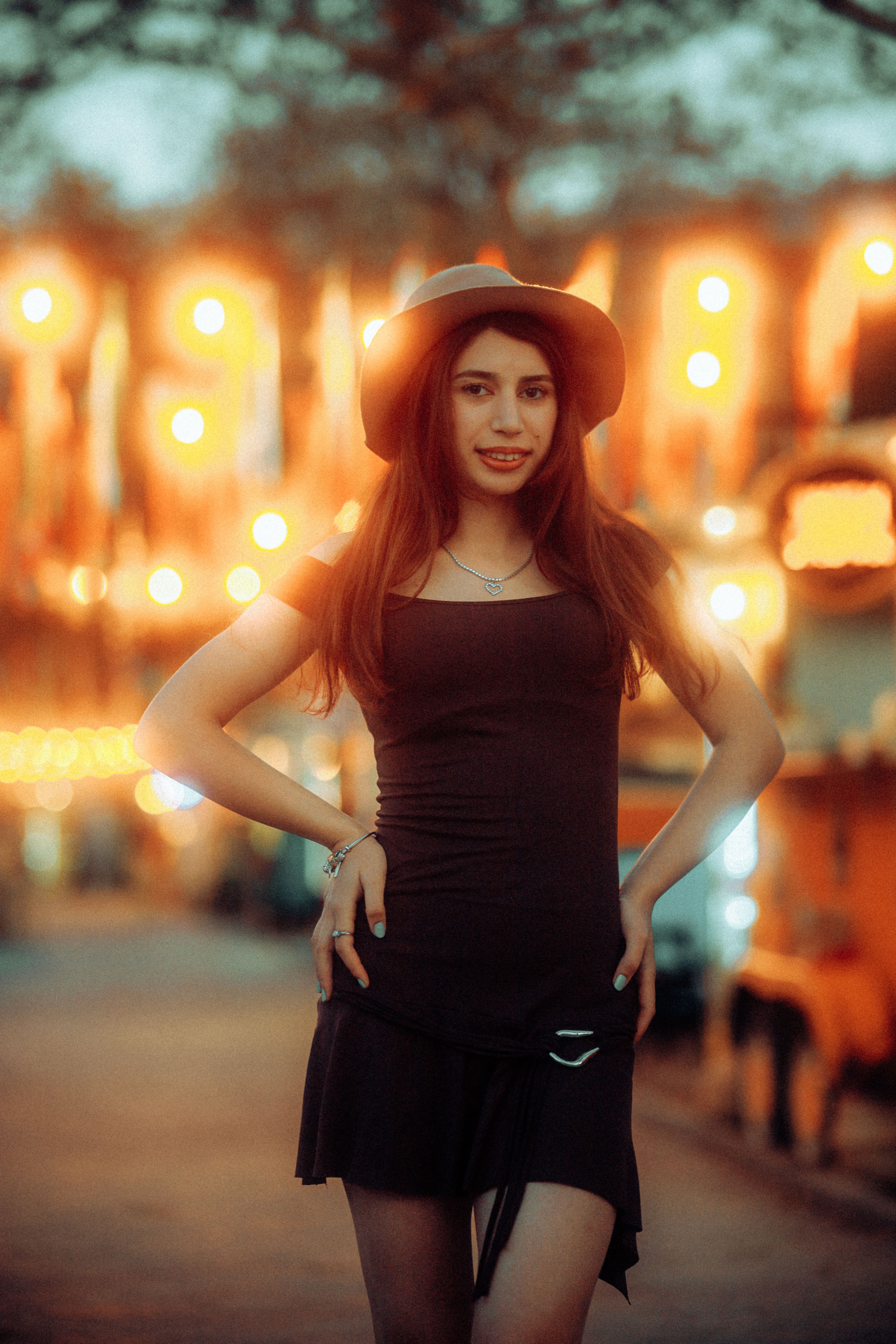Stylish Woman Posing at Night Market with Lights · Free Stock Photo