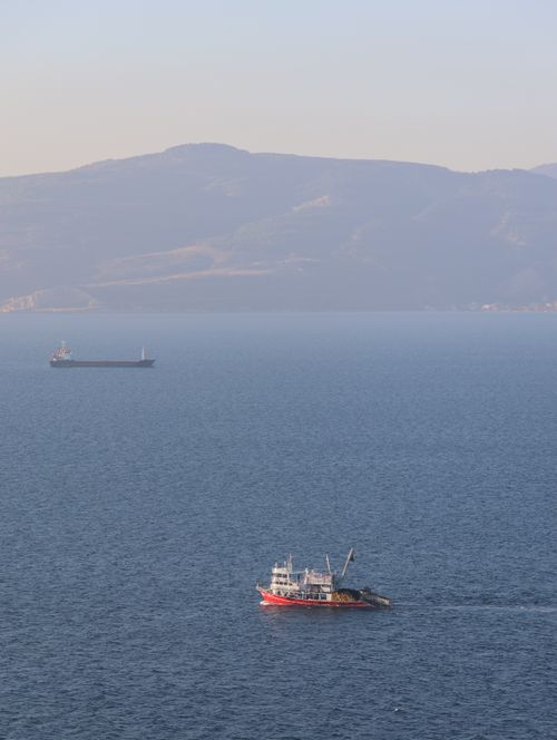 Free Two cargo ships navigate the clear blue waters of the Aegean Sea near Türkiye. Stock Photo