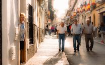 Elderly people walking on a sunny day in Arganda del Rey, showcasing local culture.