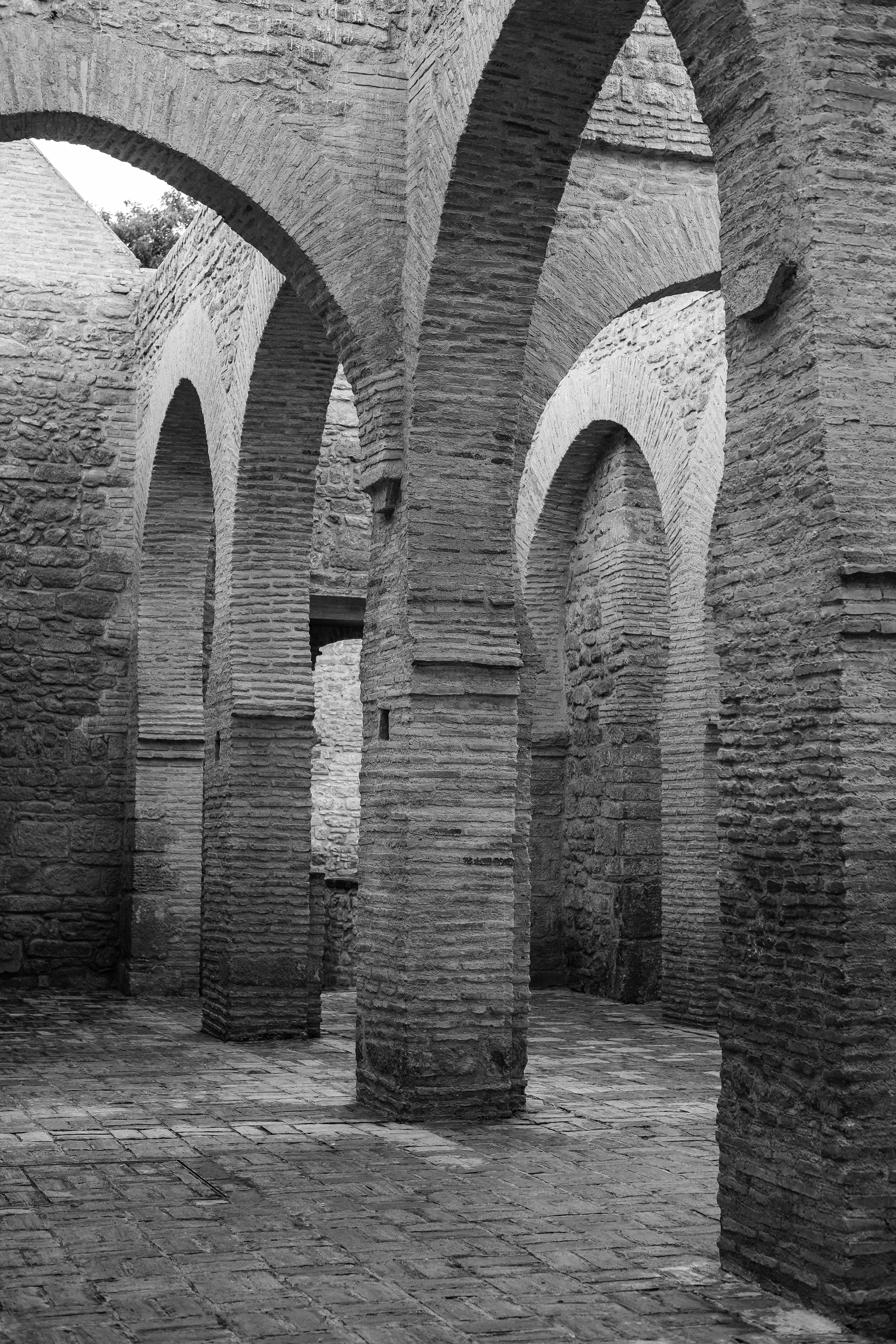 Black and white image of historic stone arches in Rabat, Morocco.