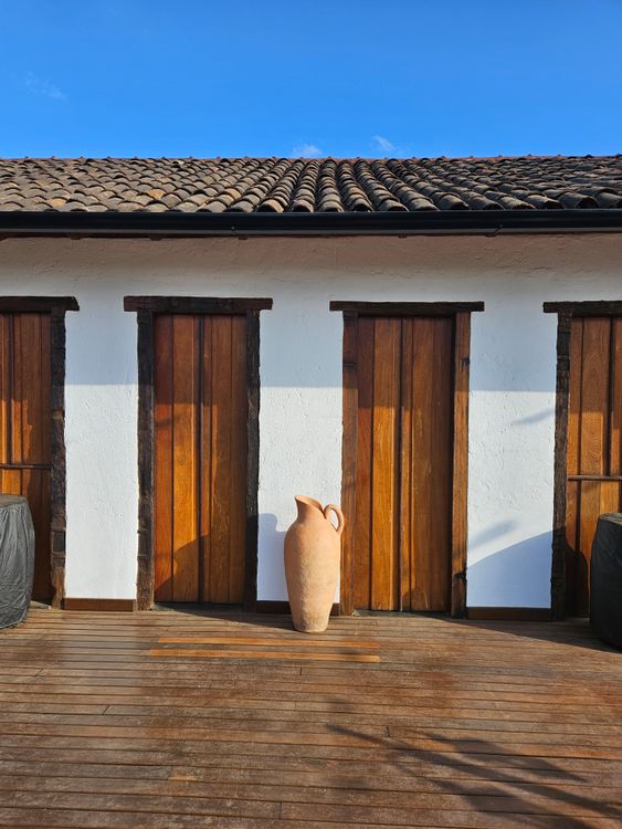 Rusticated Building Rustic Building Facade with Wooden Doors and Terracotta Vase · Free ...