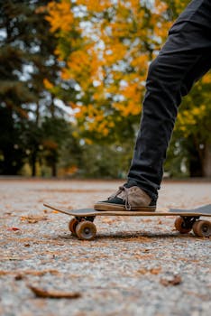 Close-up of a skateboarder's feet on a longboard in a Seattle park during fall.