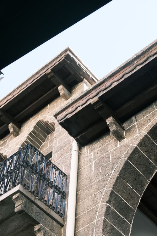 Free Close-up of historic architectural details in Diyarbakır, showcasing stone arches and iron balcony. Stock Photo