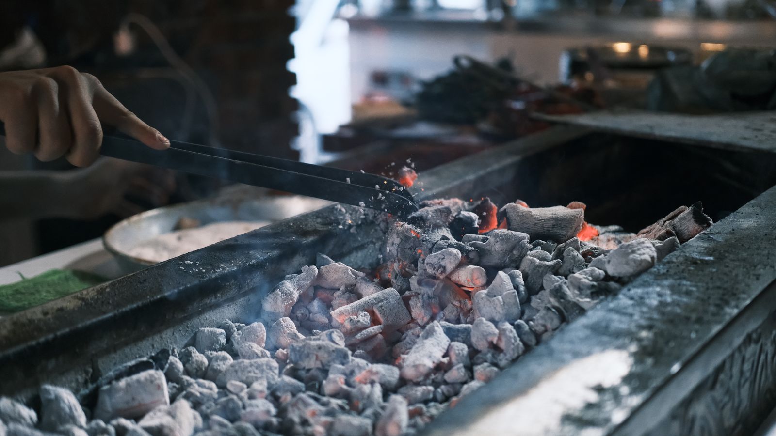 Grilling meat on glowing embers in diyarbakir, South Africa