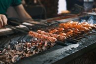Delicious traditional Turkish kebabs grilling over hot coals in Diyarbakır, showcasing authentic cuisine.
