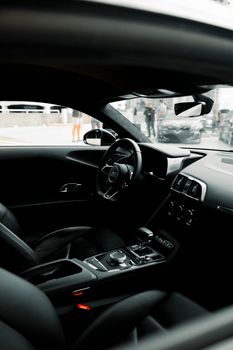 Sleek and modern luxury car interior with cityscape view through the window.