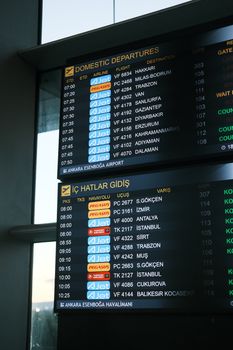 Flight information boards showing domestic departures at Ankara Esenboğa Airport.