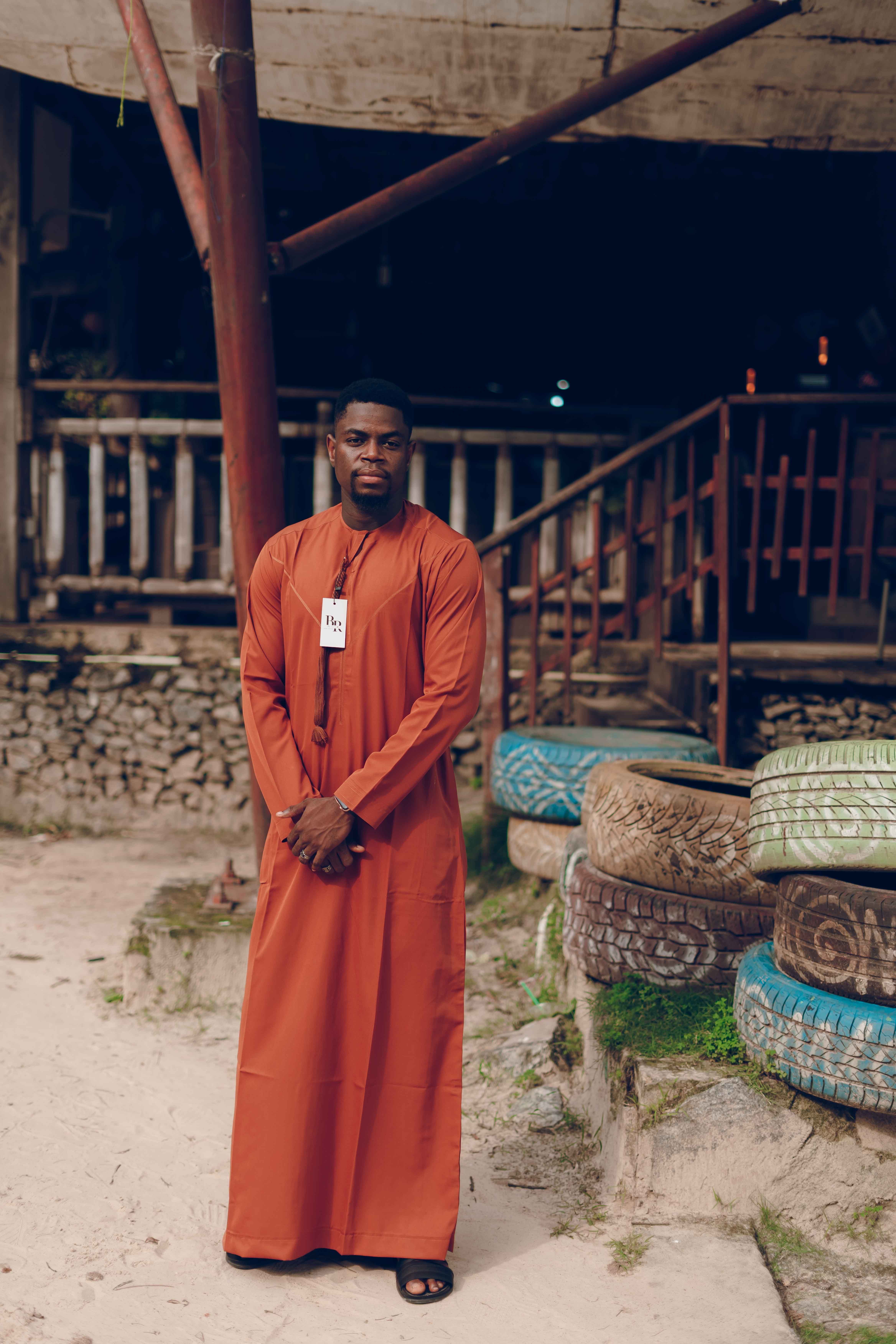 African Man Posing Outdoors in Traditional Robe · Free Stock Photo