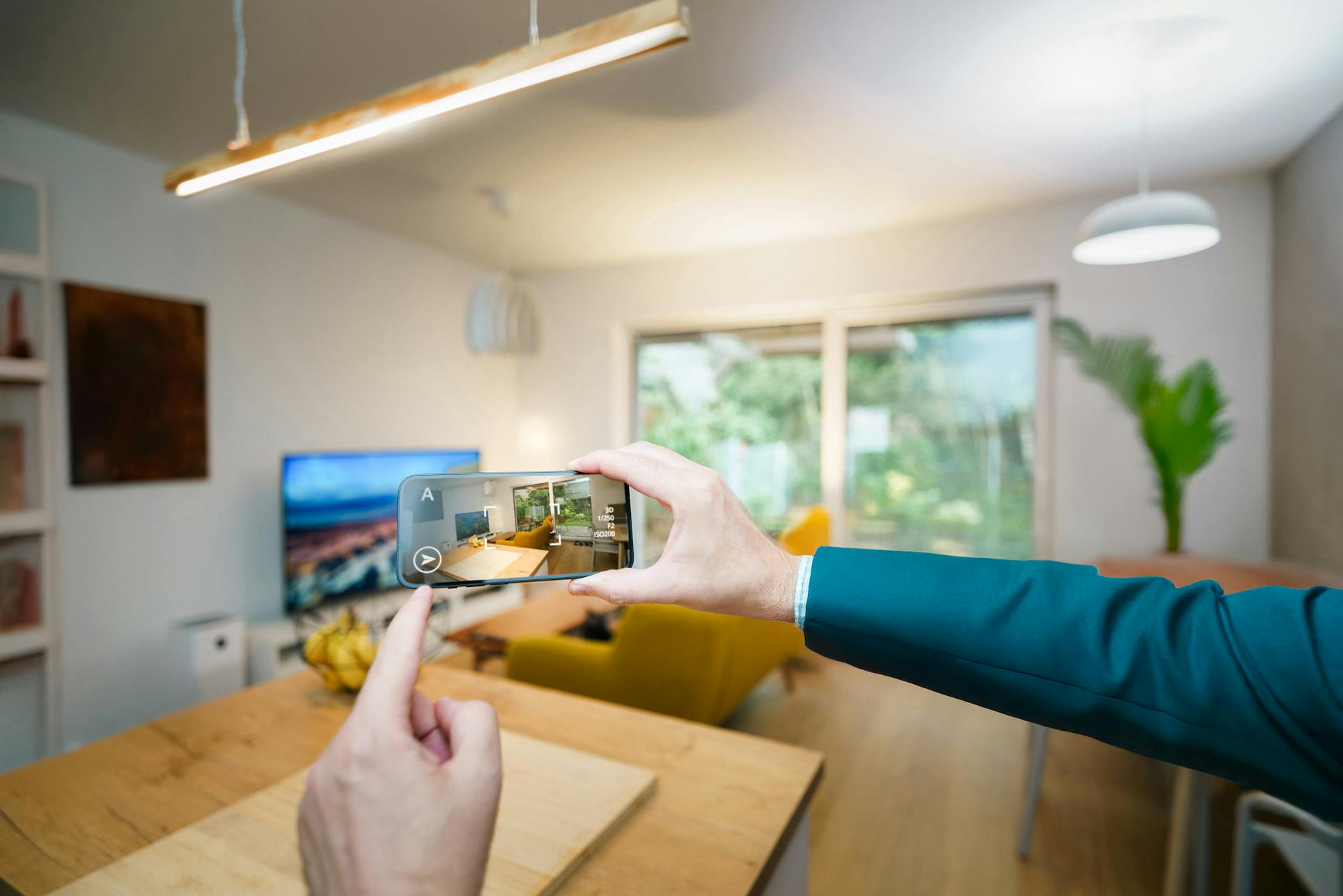 Person capturing modern living room interior smartphone