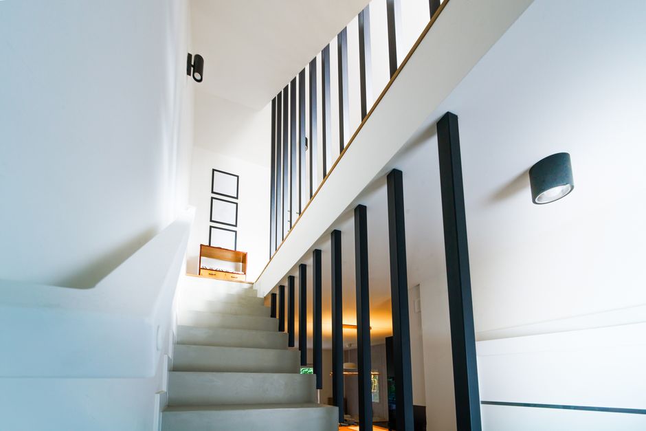 Brightly lit modern interior staircase with clean lines and minimalist decor.