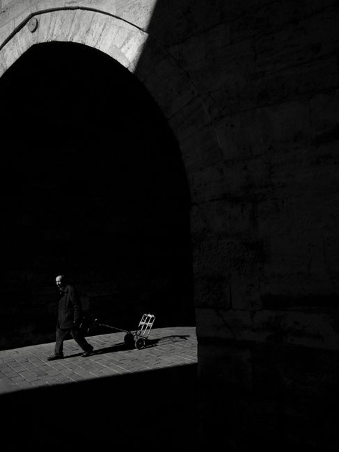 A man walks under an archway in Istanbul, capturing the city's architectural essence.