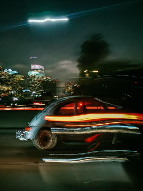 Blurred long exposure of Los Angeles car and city lights at night, showcasing dynamic urban energy.