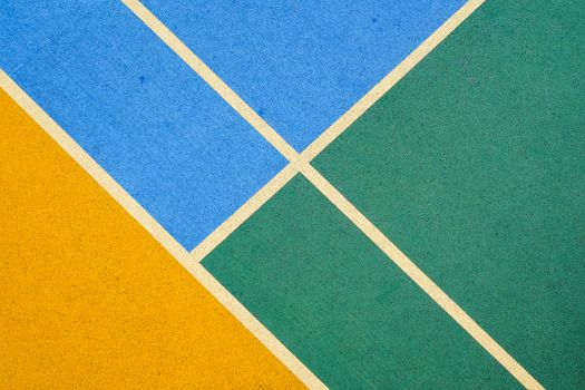 A vibrant aerial view of a geometric colored basketball court pattern.