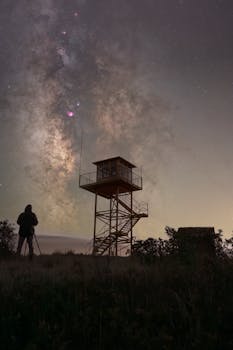 Stunning view of the Milky Way over a lookout tower in Guadalajara, Spain at night.