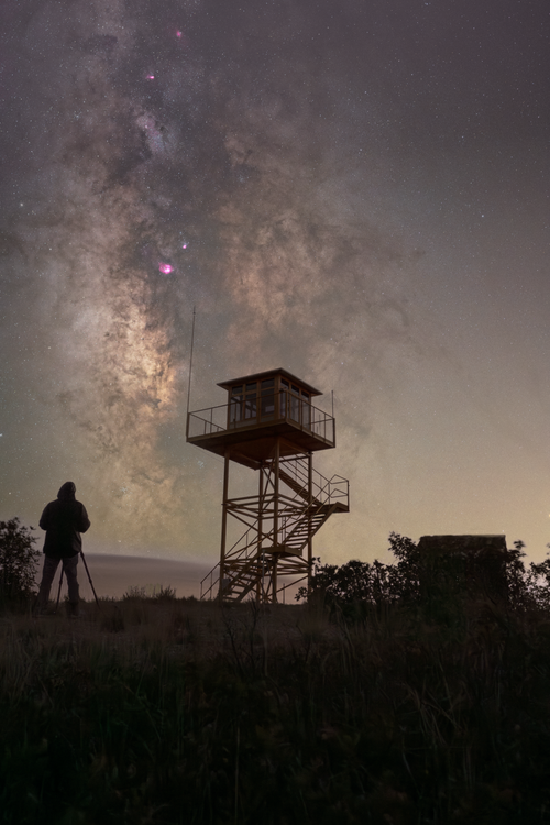 Free Stunning view of the Milky Way over a lookout tower in Guadalajara, Spain at night. Stock Photo