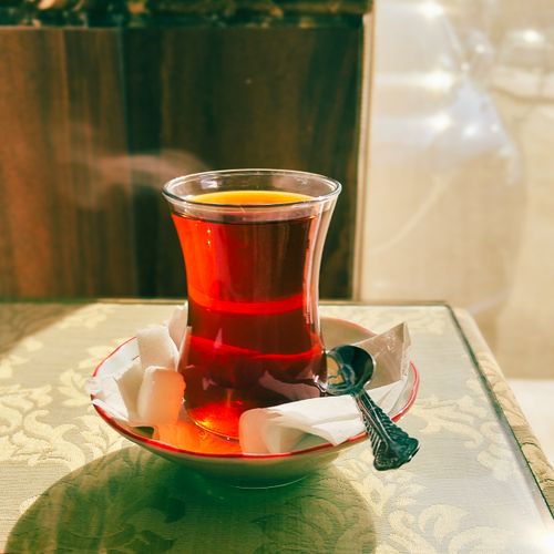 Free A steaming cup of Turkish tea served in a traditional glass with sugar cubes. Stock Photo