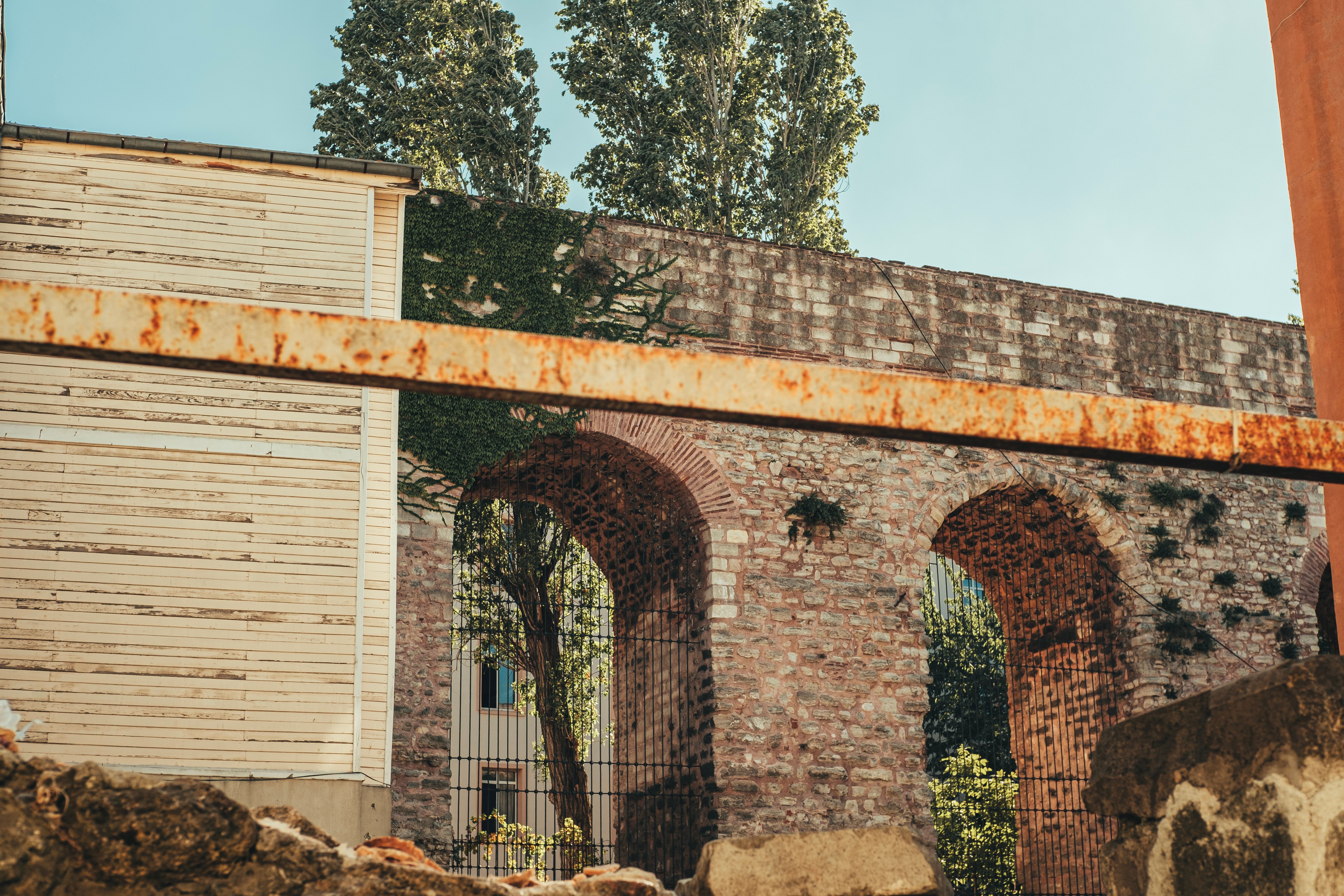 Historic Roman aqueduct arches nestled in İstanbul with rustic textures.