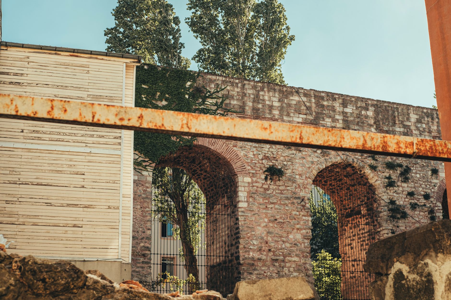 Historic Roman aqueduct arches nestled in İstanbul with rustic textures.