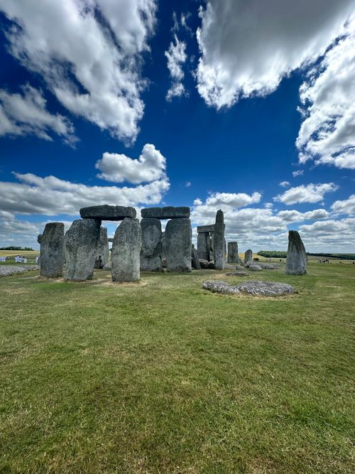 Free Capture the awe-inspiring Stonehenge under a bright blue sky with scattered clouds. Stock Photo
