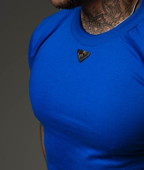 Free Close-up of a man's blue shirt with a tattooed neck and a stylish pendant. Stock Photo